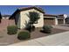 Charming single-story home featuring desert landscaping, a brown garage door, and a tile roof at 7046 N 84Th Dr, Glendale, AZ 85305