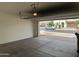Open garage door revealing a glimpse of the neighborhood and providing easy access to the street at 7046 N 84Th Dr, Glendale, AZ 85305