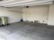 Spacious two-car garage features ample storage space with racks and a clean, concrete floor at 7046 N 84Th Dr, Glendale, AZ 85305