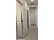 Clean hallway showcasing tiled flooring and multiple doors leading to various rooms in the house at 7046 N 84Th Dr, Glendale, AZ 85305