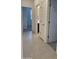 A tiled hallway with open doorways leading into other areas of the home at 7046 N 84Th Dr, Glendale, AZ 85305
