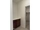 Hallway with built-in cabinets with countertop leading to walk-in closet with shelves at 7046 N 84Th Dr, Glendale, AZ 85305