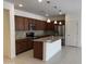A spacious kitchen features brown cabinets, granite countertops, and stainless steel appliances at 7046 N 84Th Dr, Glendale, AZ 85305
