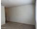 Spacious living room featuring neutral carpet, a large window, and ample natural light at 7046 N 84Th Dr, Glendale, AZ 85305