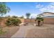 Backyard with a brick-paved path leading to a fire pit surrounded by bench seating at 7309 W Getty Dr, Phoenix, AZ 85043