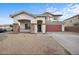 Charming two-story home with a red two-car garage, stone accents, and a covered front porch at 7309 W Getty Dr, Phoenix, AZ 85043