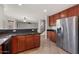 Open kitchen with granite countertops, stainless steel appliances, and tile flooring overlooking living area at 7309 W Getty Dr, Phoenix, AZ 85043