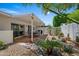 Serene backyard oasis featuring a covered patio with dining set, rock garden, and mature palm trees at 7630 E Pasadena Ave, Scottsdale, AZ 85250