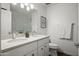 Bright bathroom featuring a double sink vanity, ample lighting, and a large framed mirror at 7630 E Pasadena Ave, Scottsdale, AZ 85250