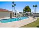 Sparkling community pool surrounded by lush greenery and palm trees, perfect for relaxation and recreation at 7630 E Pasadena Ave, Scottsdale, AZ 85250