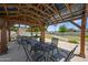 Community gazebo with tables, chairs, and a view of the pool and surrounding green space, perfect for gatherings at 7630 E Pasadena Ave, Scottsdale, AZ 85250