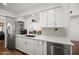 Bright kitchen featuring white cabinetry, stainless steel appliances, and a modern design at 7630 E Pasadena Ave, Scottsdale, AZ 85250