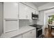 Modern kitchen with stainless steel appliances, white cabinets, and sleek countertops at 7630 E Pasadena Ave, Scottsdale, AZ 85250