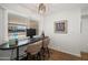 Bright office nook with desk, chair, and natural light from the window at 7630 E Pasadena Ave, Scottsdale, AZ 85250
