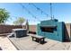 Backyard oasis featuring a hot tub, built-in barbecue, and stylish desert landscaping at 7824 S 33Rd Ln, Laveen, AZ 85339