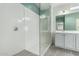 Bright bathroom features a shower with glass door, modern fixtures and dual sinks and modern lighting at 7824 S 33Rd Ln, Laveen, AZ 85339
