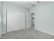 A bedroom with white closet doors offers an adjacent view into an attached bathroom at 7824 S 33Rd Ln, Laveen, AZ 85339