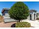 Well-maintained front yard with mature tree providing shade and curb appeal at 7824 S 33Rd Ln, Laveen, AZ 85339