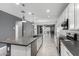 Spacious kitchen with stainless steel appliances, a large island, white cabinets, and an open floor plan at 7824 S 33Rd Ln, Laveen, AZ 85339