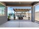A covered outdoor patio area features an outdoor kitchen with a pergola at 7824 S 33Rd Ln, Laveen, AZ 85339