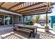 Relaxing outdoor patio with a dining table, seating, and stylish pergola for shade at 7824 S 33Rd Ln, Laveen, AZ 85339