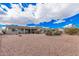 This house has a large back yard, desert landscaping, mature trees, and a covered patio for outdoor enjoyment at 8248 E Emelita Ave, Mesa, AZ 85208