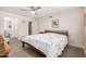 Bedroom with wood-look floors, ceiling fan, and ensuite bathroom at 8248 E Emelita Ave, Mesa, AZ 85208