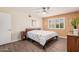 A calming bedroom with wood-look floors, ceiling fan, and natural light at 8248 E Emelita Ave, Mesa, AZ 85208