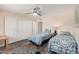 Cozy bedroom with ceiling fan, two twin beds, and closet at 8248 E Emelita Ave, Mesa, AZ 85208