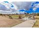 Scenic view of the bocce ball court featuring well-maintained greens, benches and walking paths at 8248 E Emelita Ave, Mesa, AZ 85208