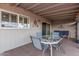 A covered patio features a table with chairs and comfortable seating to relax and enjoy outdoor living at 8248 E Emelita Ave, Mesa, AZ 85208