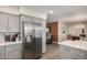 A kitchen featuring stainless steel refrigerator and view to a living area and dining room at 8248 E Emelita Ave, Mesa, AZ 85208
