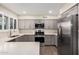 Contemporary kitchen with gray cabinets, stainless steel appliances and quartz countertop at 8248 E Emelita Ave, Mesa, AZ 85208