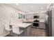 Modern kitchen featuring gray cabinetry, stainless steel appliances and breakfast bar at 8248 E Emelita Ave, Mesa, AZ 85208