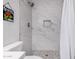 A stylish shower with marble-look tile, mosaic flooring, and built-in niche at 8248 E Emelita Ave, Mesa, AZ 85208