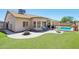 A beautiful backyard with a pool, artificial grass, covered patio, and seating area at 10138 W Oregon Ave, Glendale, AZ 85307