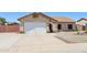 A single-story home with a two-car garage, neutral color palette, and desert landscaping for easy maintenance at 10138 W Oregon Ave, Glendale, AZ 85307