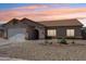 Charming single-story home featuring neutral tones, a two-car garage, and a well-maintained desert landscape at 10138 W Oregon Ave, Glendale, AZ 85307