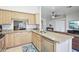 Charming kitchen showcasing granite counters, wood cabinetry, stainless appliances, and an open layout at 10138 W Oregon Ave, Glendale, AZ 85307