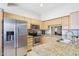 Well-appointed kitchen boasting stainless steel appliances, granite countertops, and ample cabinet space at 10138 W Oregon Ave, Glendale, AZ 85307