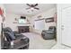 Cozy living room with bar and shelves, ceiling fan, carpet, and comfortable seating at 10138 W Oregon Ave, Glendale, AZ 85307