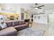 Open-concept living room featuring tile flooring, a comfortable sectional sofa, and seamless flow into the kitchen at 10138 W Oregon Ave, Glendale, AZ 85307