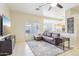 Inviting living space featuring a comfortable sofa, tile flooring, and easy access to the kitchen at 10138 W Oregon Ave, Glendale, AZ 85307