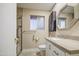 Updated bathroom featuring a modern vanity, neutral tiling, and a glass-enclosed shower at 10620 W Clair Dr, Sun City, AZ 85351