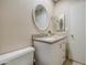 Bathroom with light walls, stylish white vanity and framed oval mirror at 10620 W Clair Dr, Sun City, AZ 85351