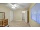Inviting bedroom with neutral carpeting, a ceiling fan, a closet, and window at 10620 W Clair Dr, Sun City, AZ 85351