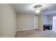 Spacious bedroom with carpeting, a ceiling fan, a window, and desk area at 10620 W Clair Dr, Sun City, AZ 85351