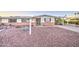 Charming single-story home with a low brick wall and desert landscaping featuring gravel and sparse vegetation at 10620 W Clair Dr, Sun City, AZ 85351