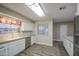 Bright kitchen with stainless steel appliances, white cabinets, and a stylish backsplash, perfect for modern living at 10620 W Clair Dr, Sun City, AZ 85351