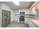 Contemporary kitchen equipped with stainless steel appliances, ample cabinet space, and modern finishes at 10620 W Clair Dr, Sun City, AZ 85351